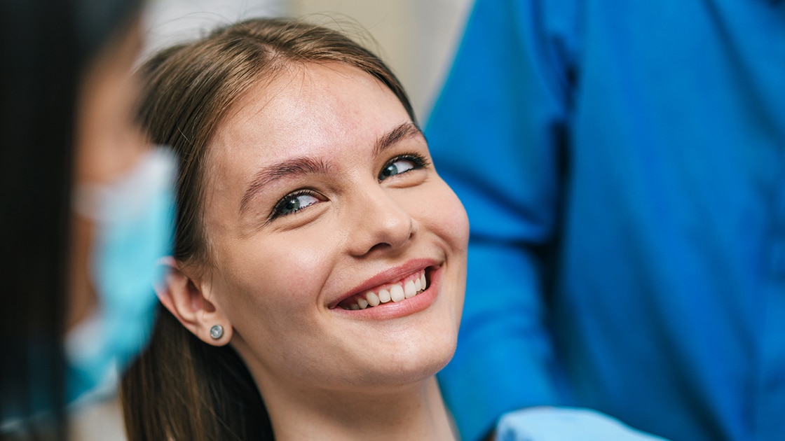 Teen smiling at dentist